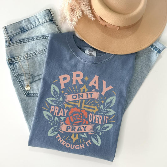 a hat, jeans, and a t - shirt on a white surface