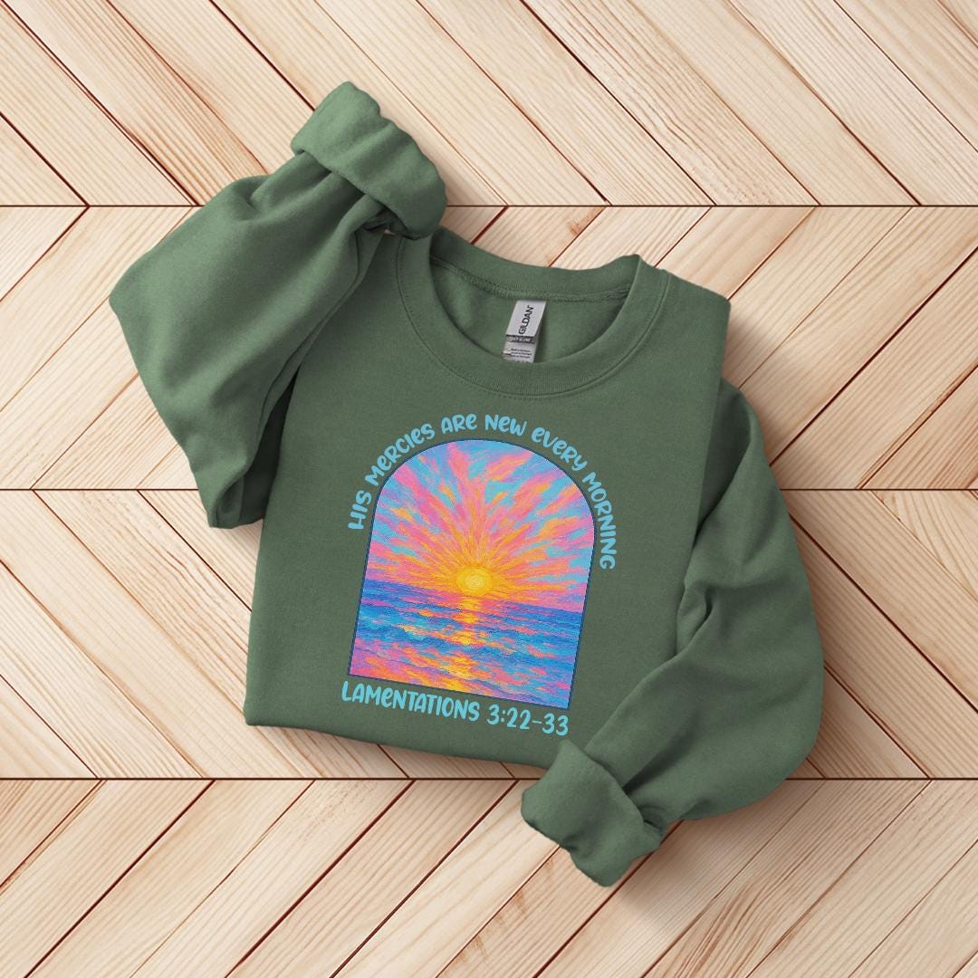 a green shirt with a picture of a sunset on it