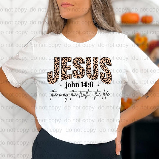 A woman wearing a white t-shirt with a leopard print design and text printed on it.