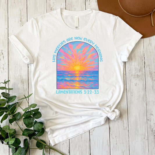 a white t - shirt with a painting of a sunset on it