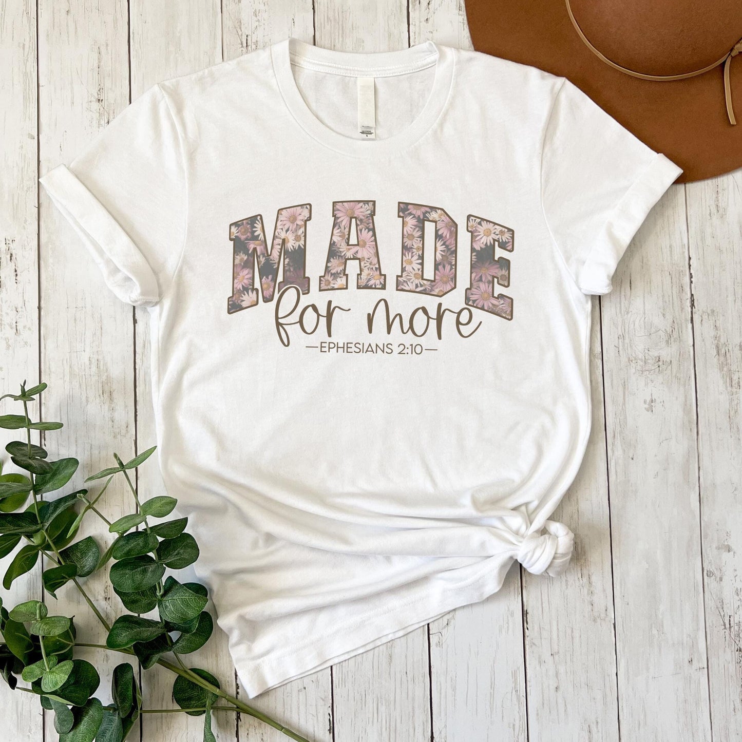 a white t - shirt with the words made for more printed on it