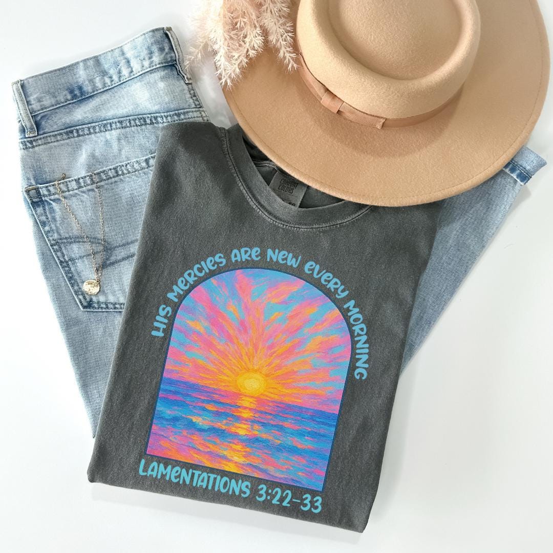 a hat, jeans, and a t - shirt on a white surface