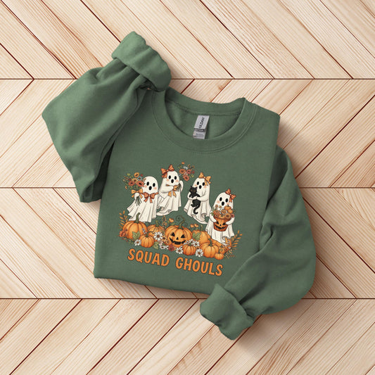 A green sweatshirt with a graphic design featuring four ghostly figures and pumpkins, along with the text "SQUAD CHOULS" printed on it.