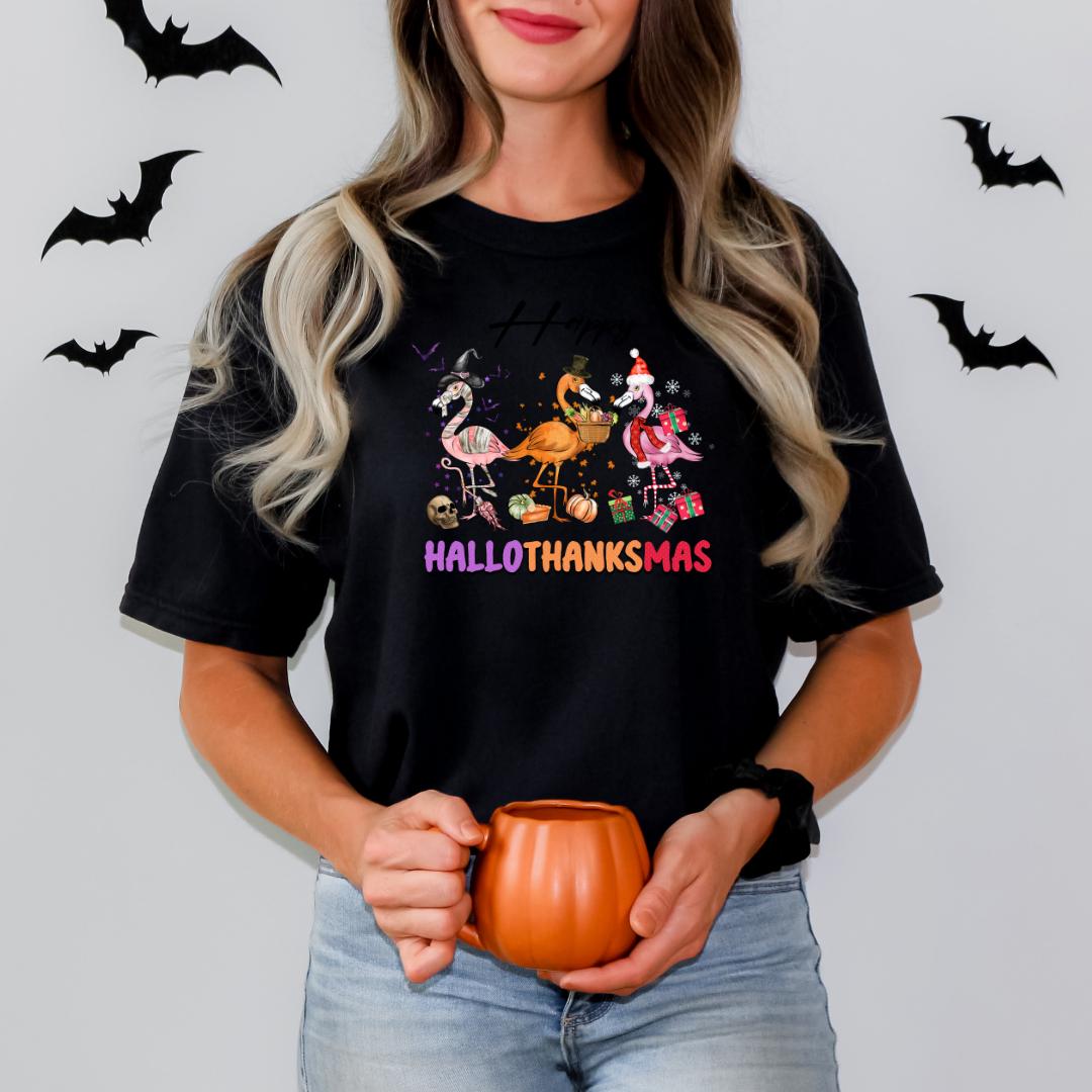 A woman wearing a black t-shirt with a Halloween-themed graphic and holding a pumpkin-shaped mug.
