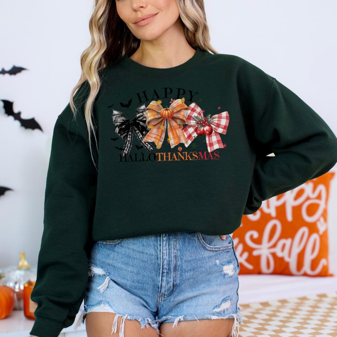 A woman wearing a green sweatshirt with a graphic design of Halloween-themed bows and the text "Happy Halloween! All things thanksmas" stands in front of a Halloween-themed background.