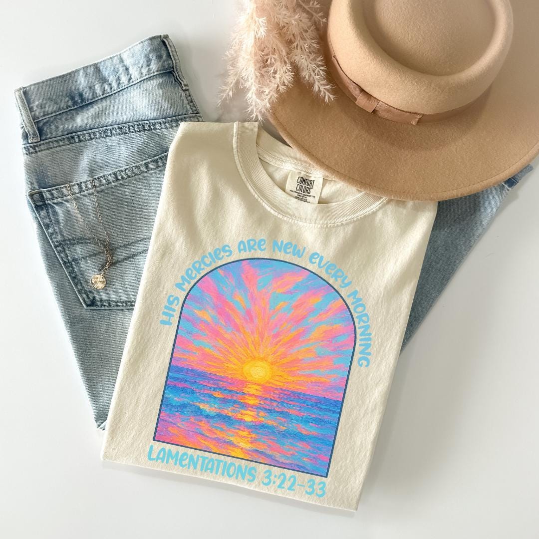a hat, jeans, and t - shirt on a white surface