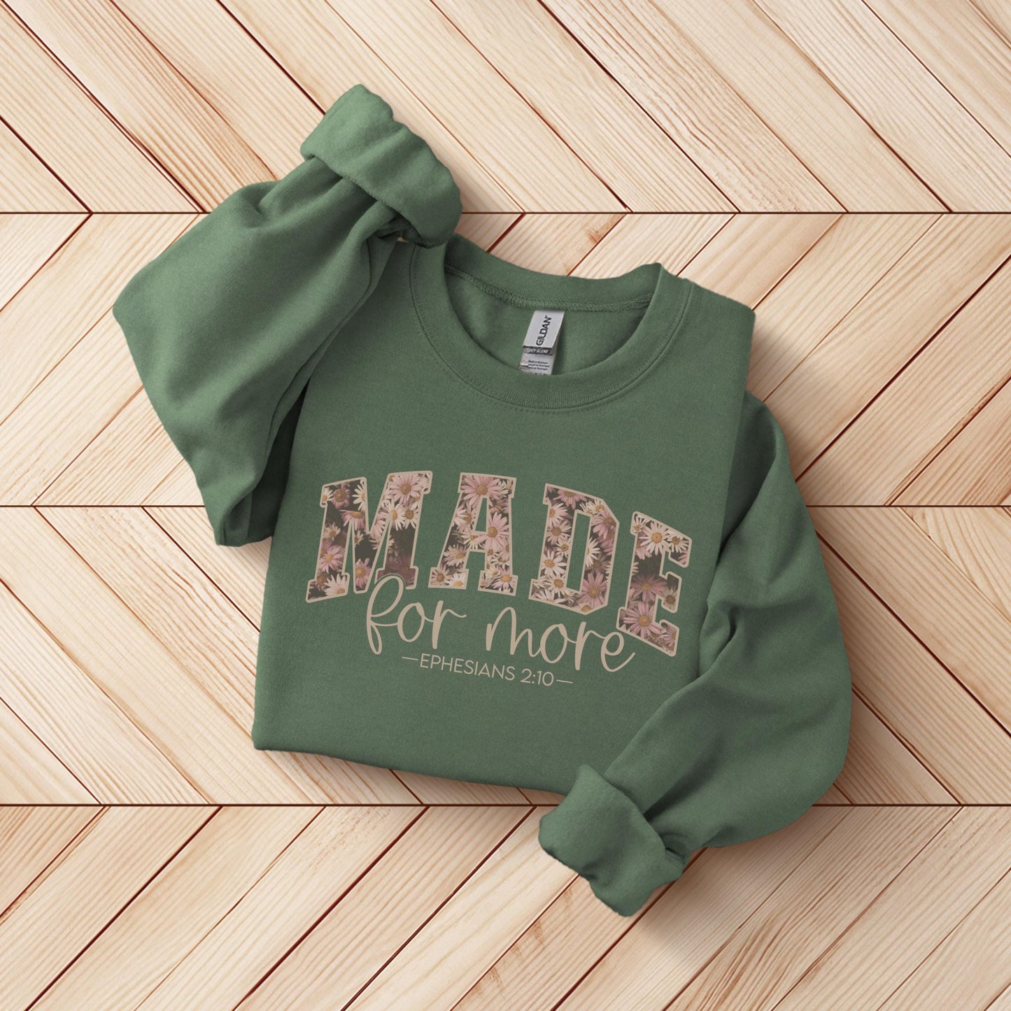 a green sweatshirt with the words made for more printed on it