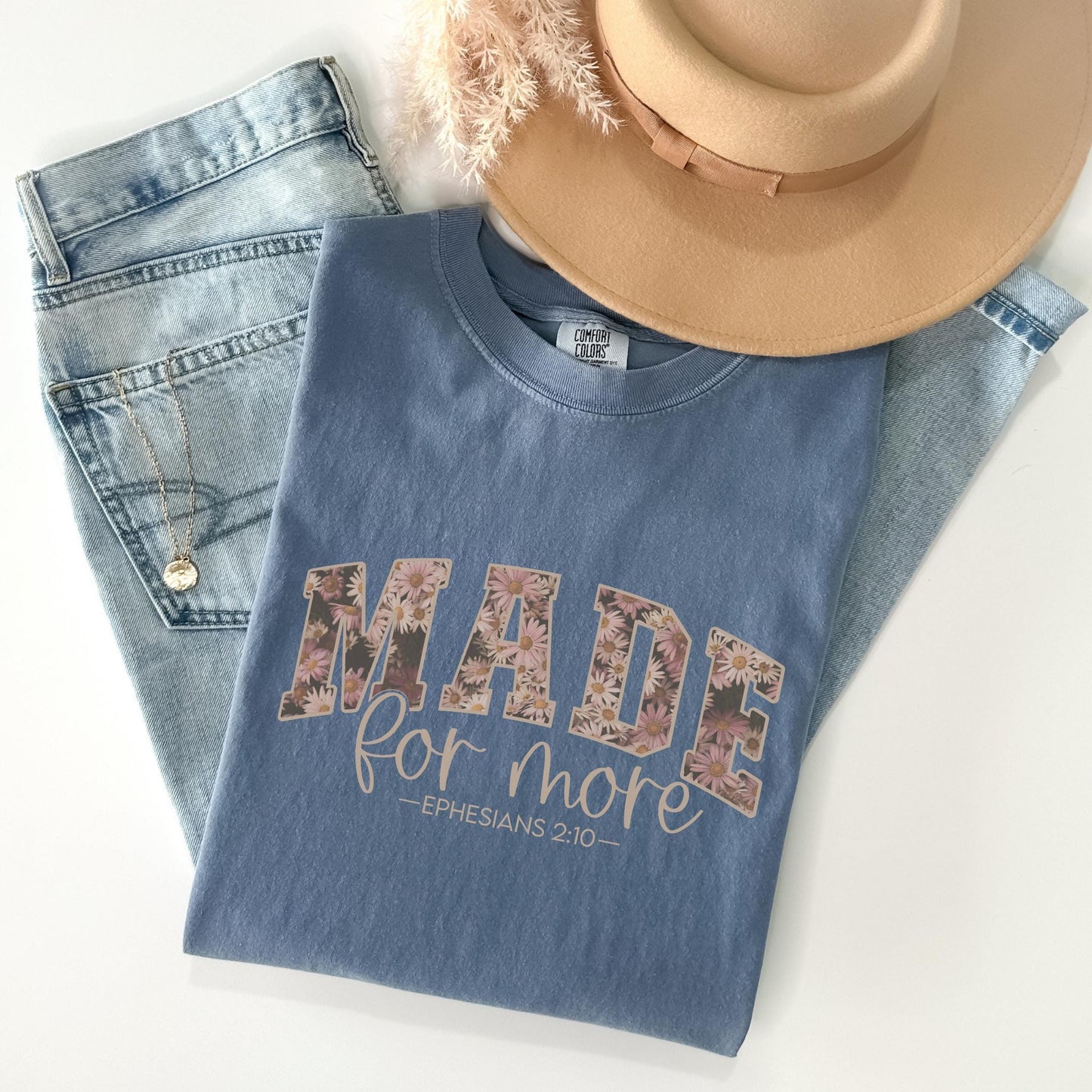 a hat, jeans, and a t - shirt that says made for more